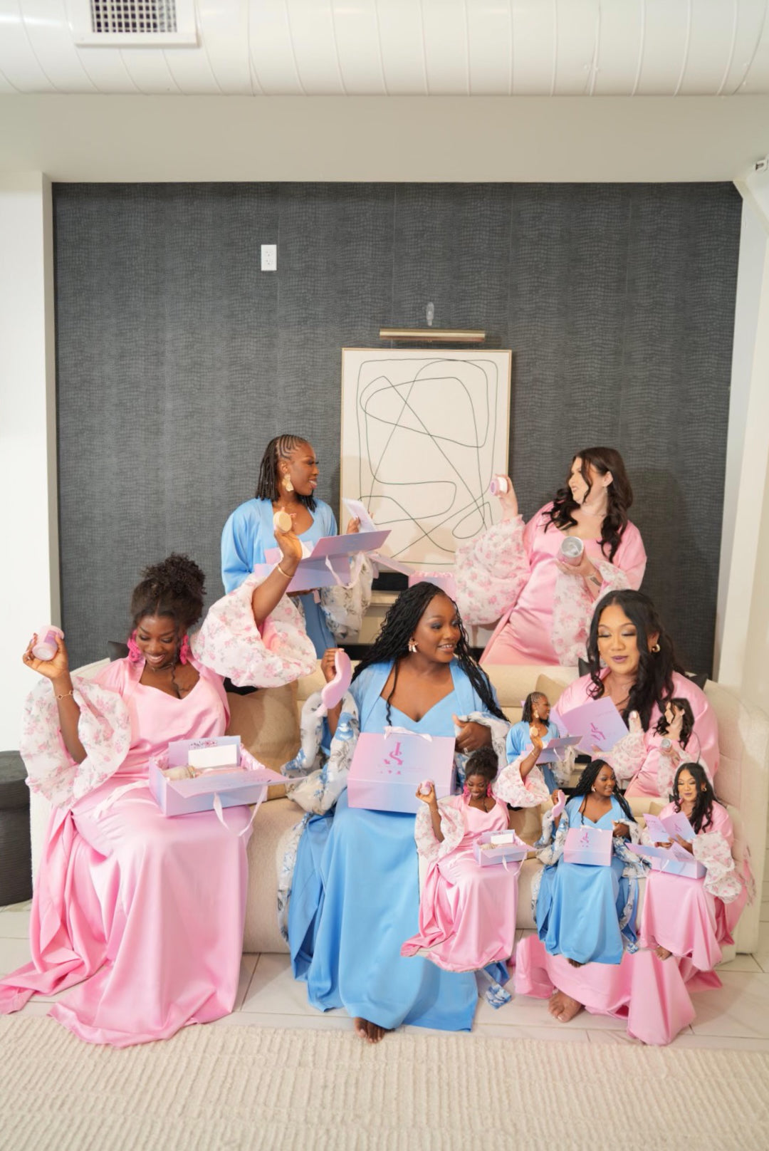 Women wearing a pink and blue satin intentional soft mom robe with lace trim