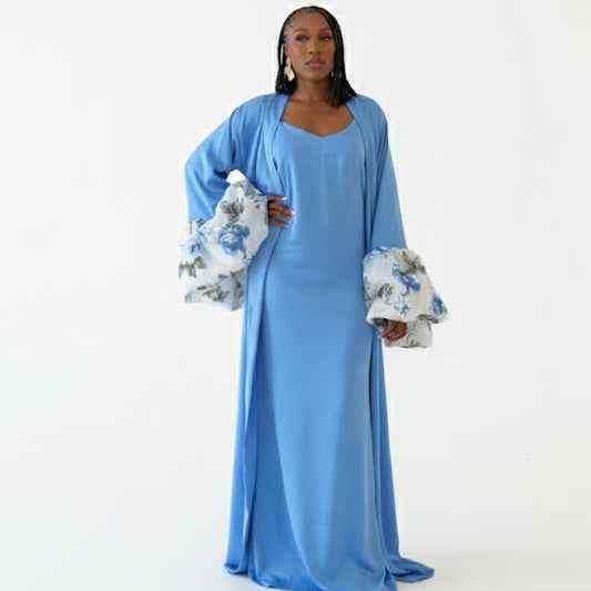 Woman wearing a pink satin intentional soft mom robe with floral sleeves